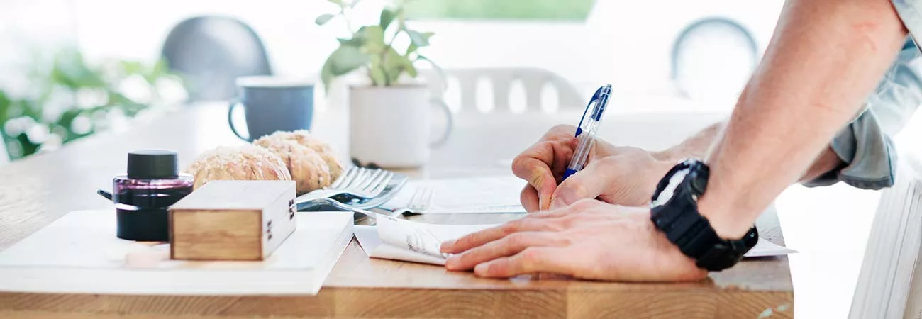 hands writing in anotebook