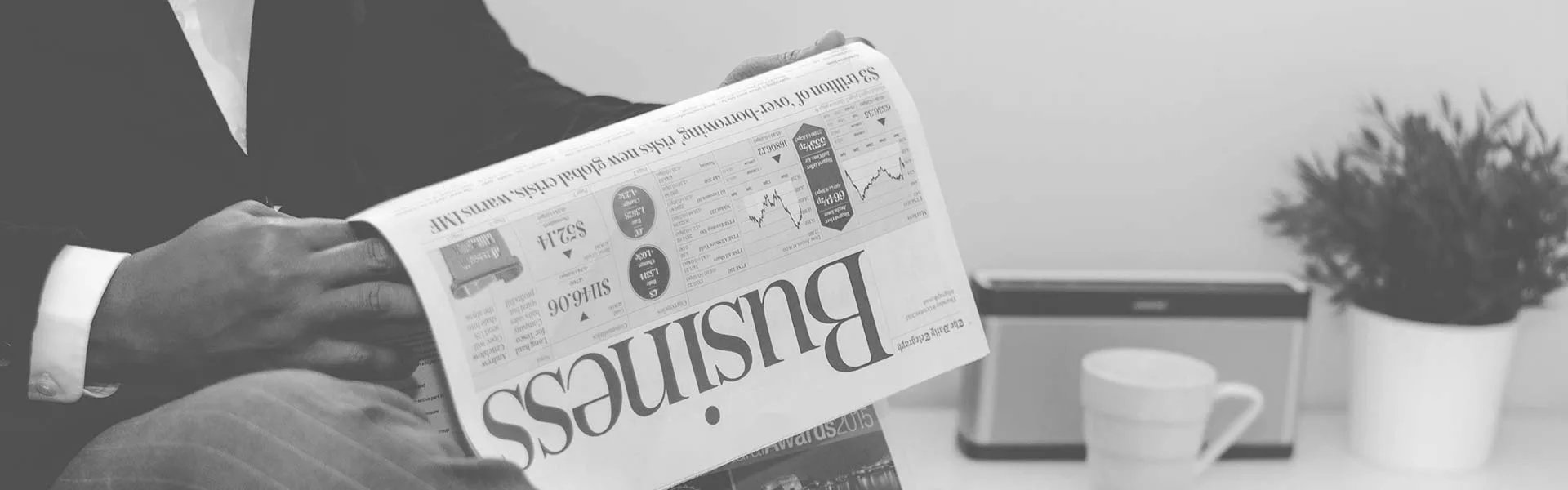 business newspaper held upside down
