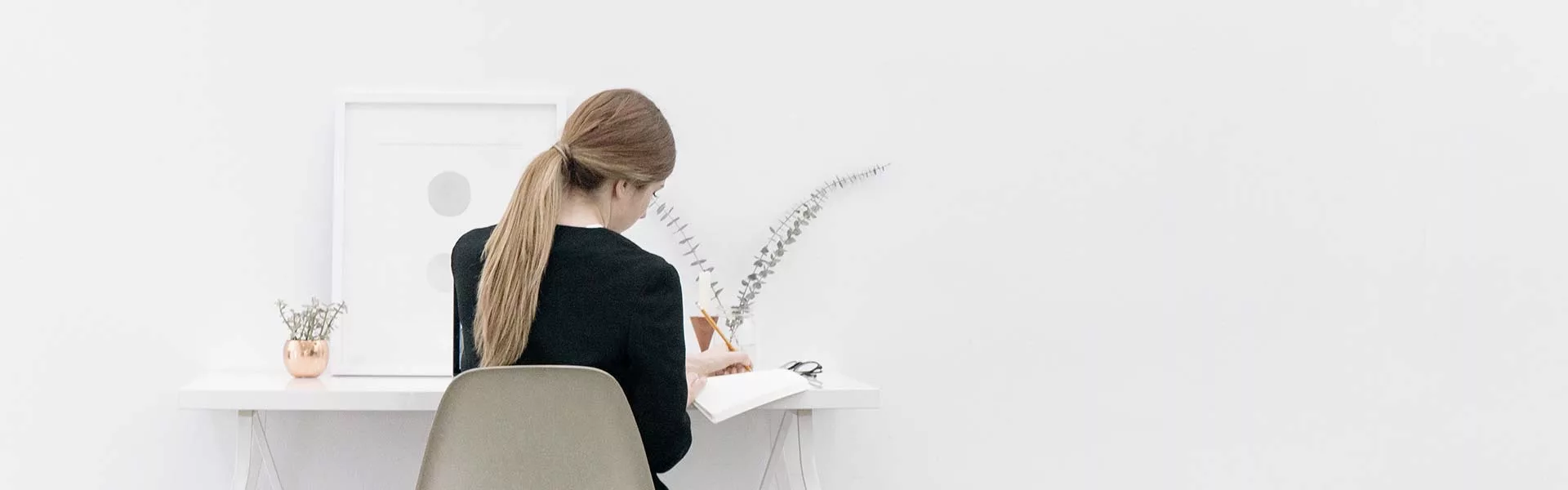 woman sitting by a desk, simplistic white image