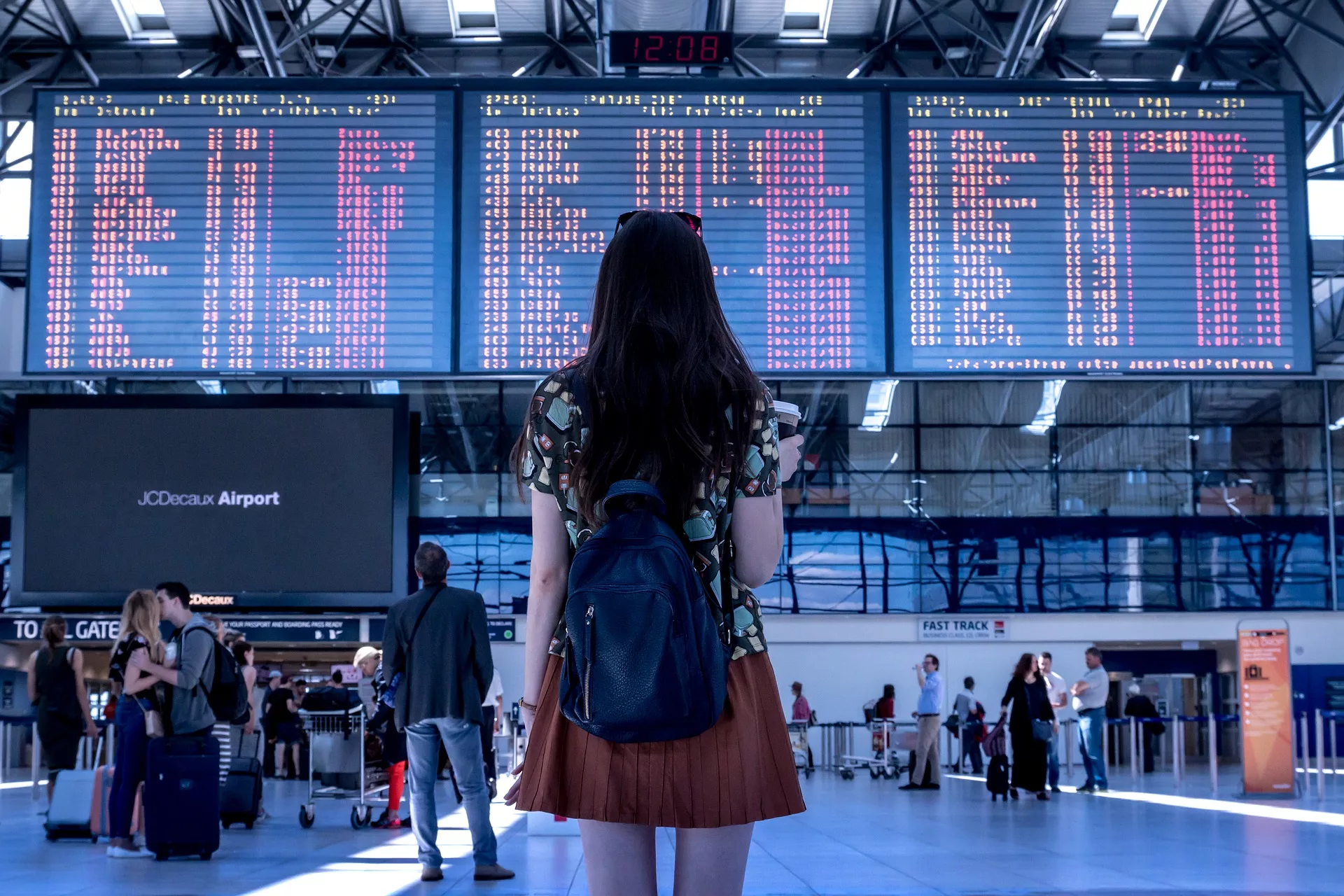 woman looking at arrivals/departures at an airport