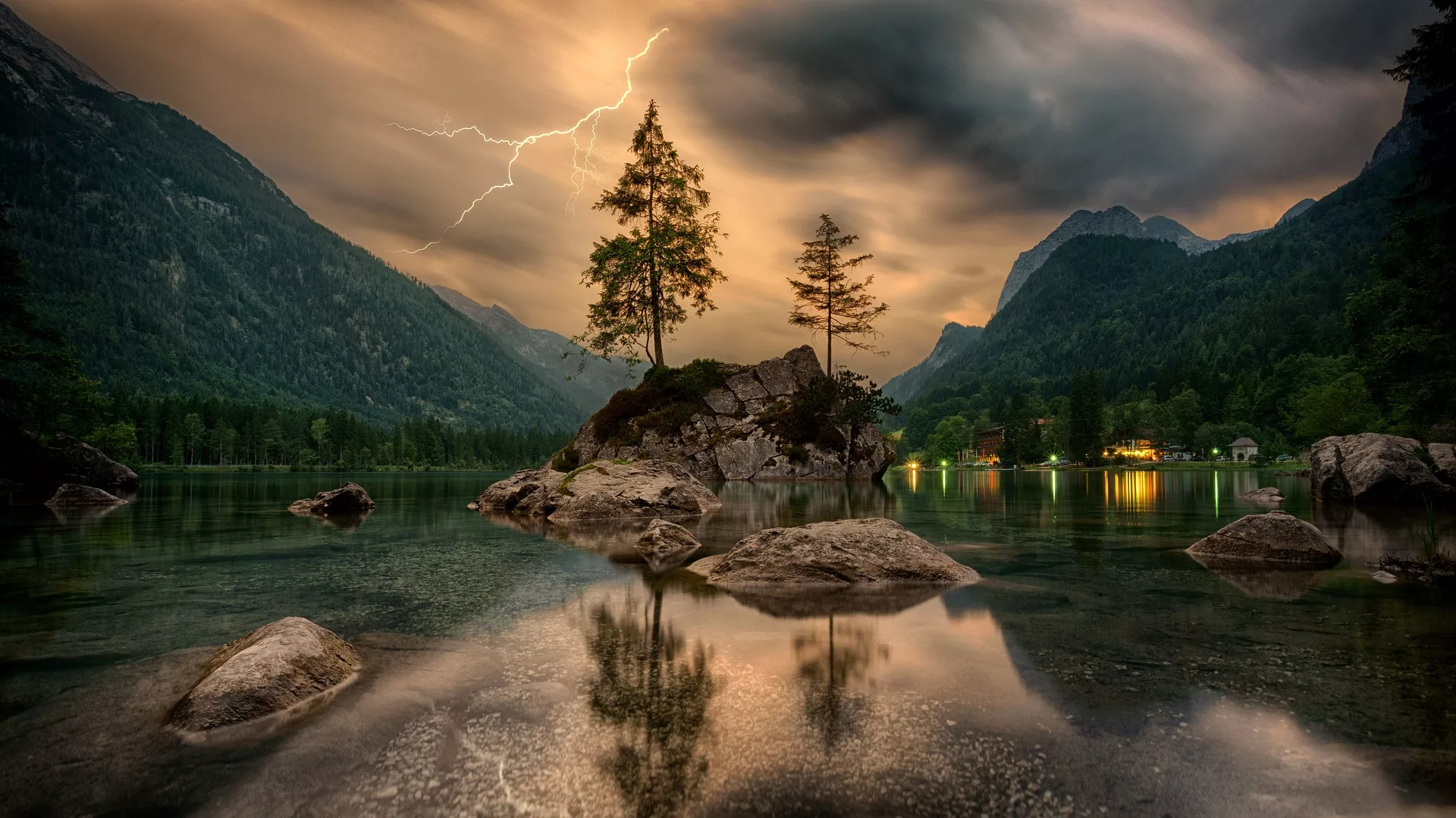 mountains and trees reflecting in a still lake