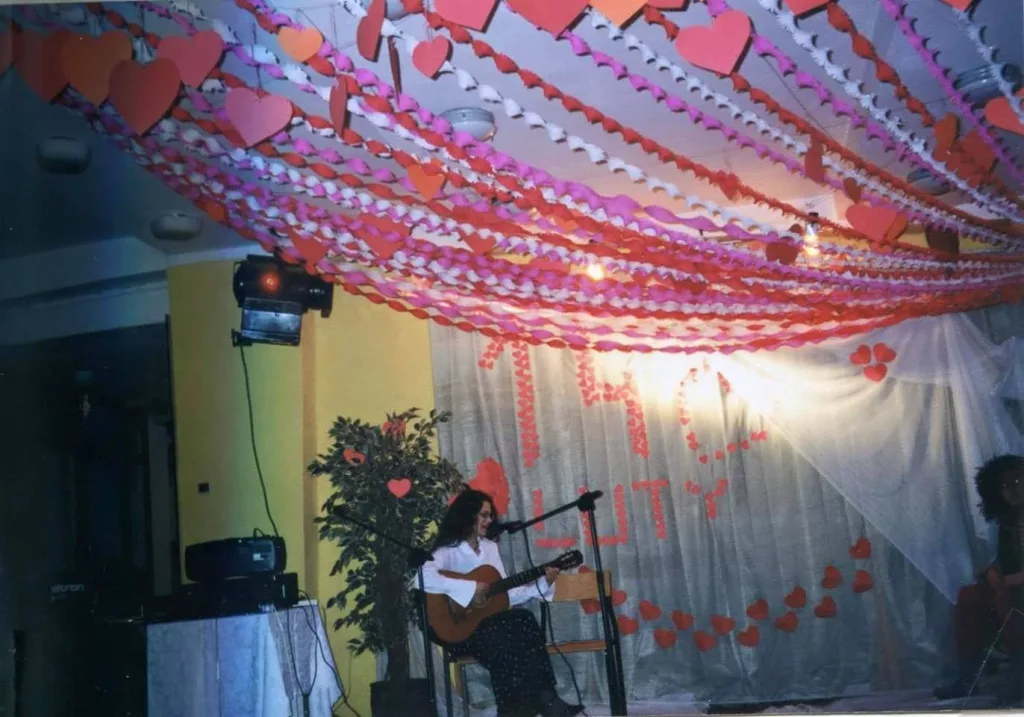 A girl playing guitar in front of a microphone